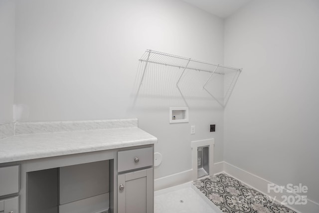 laundry area featuring cabinets, light tile patterned flooring, hookup for an electric dryer, and washer hookup