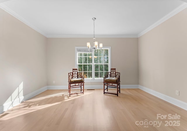 living area with a chandelier, light hardwood / wood-style flooring, and crown molding