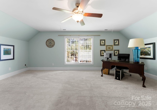 carpeted home office with ceiling fan and vaulted ceiling