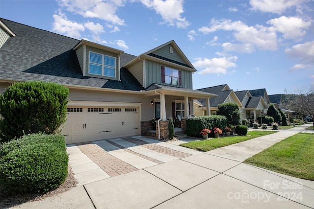 craftsman-style house featuring covered porch and a garage