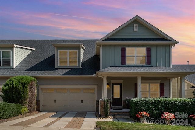 view of front of home featuring a garage and a porch