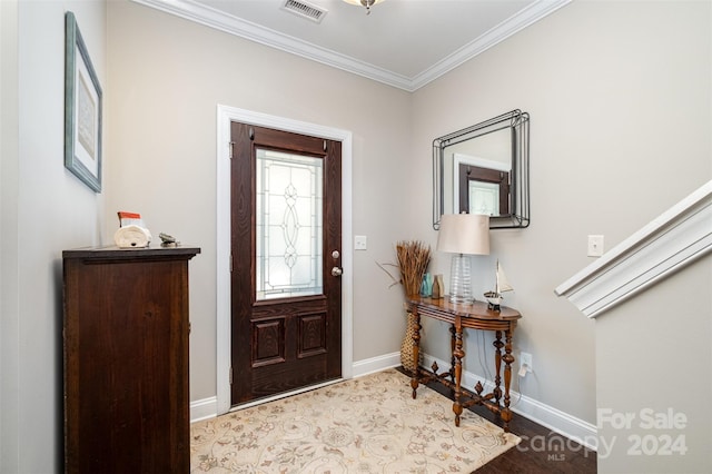 foyer entrance with hardwood / wood-style flooring and crown molding