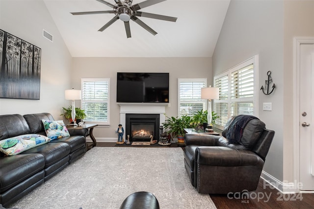 living room featuring high vaulted ceiling, ceiling fan, and wood-type flooring