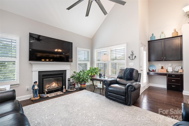 living room with ceiling fan, dark hardwood / wood-style flooring, high vaulted ceiling, and a healthy amount of sunlight