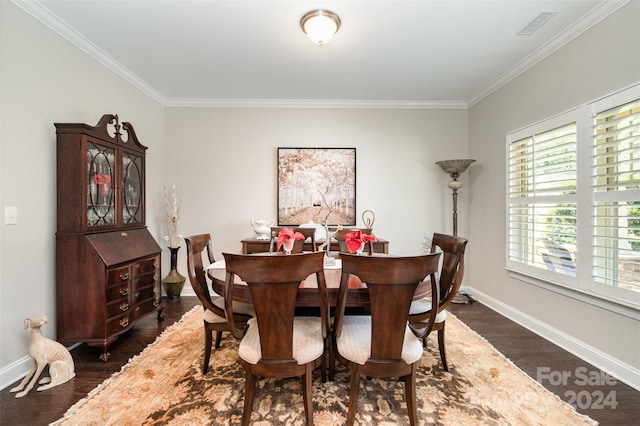 dining space with crown molding and dark wood-type flooring