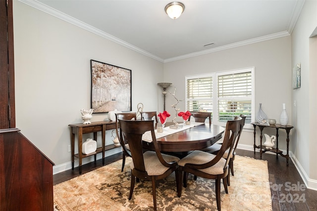 dining area with dark hardwood / wood-style floors and ornamental molding