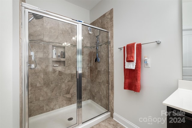 bathroom with walk in shower and vanity