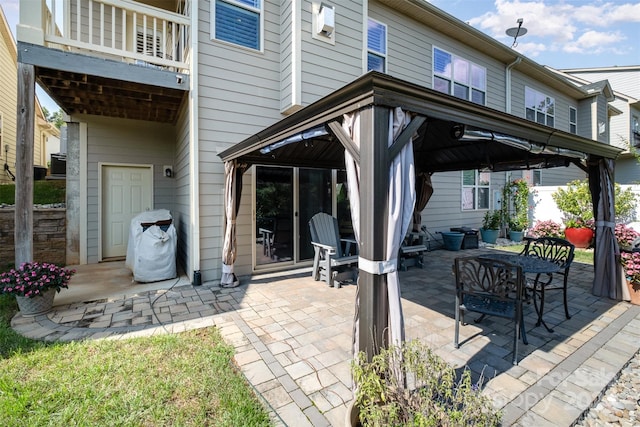 view of patio / terrace with a balcony and a gazebo