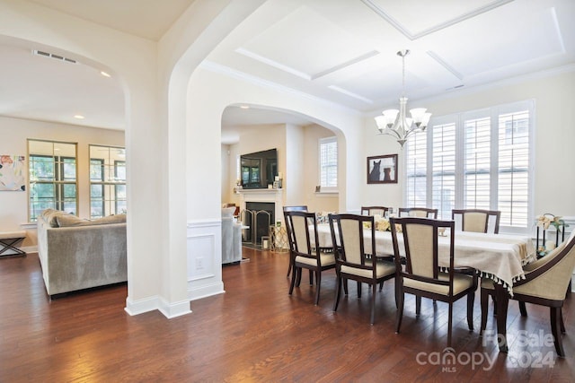 dining room featuring a notable chandelier, dark hardwood / wood-style floors, and ornamental molding