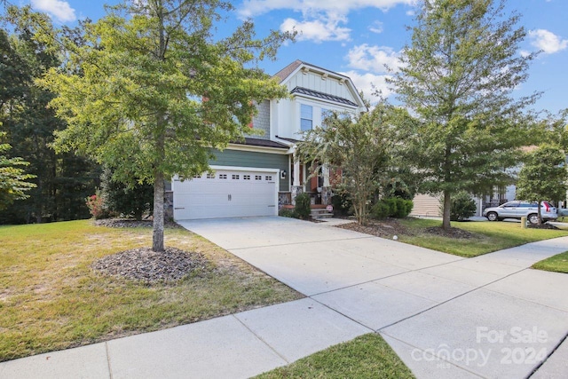 view of front of property with a garage and a front yard