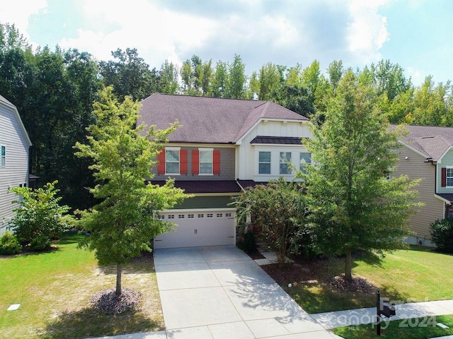 view of front of property featuring a front yard and a garage