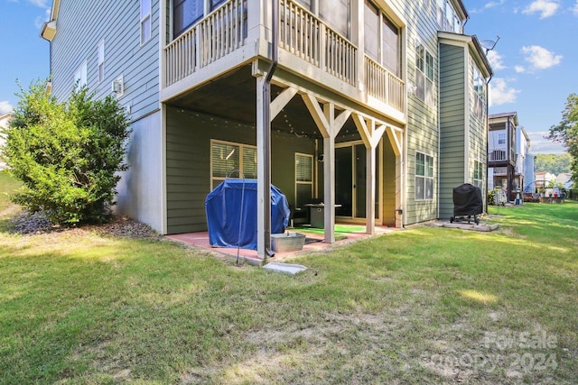 back of house with a lawn