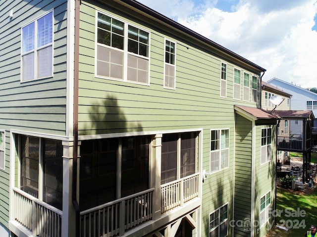 view of property exterior featuring a sunroom