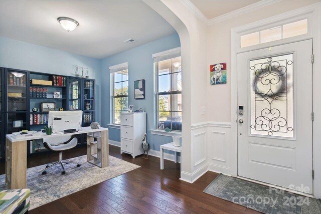 entryway with ornamental molding and dark wood-type flooring