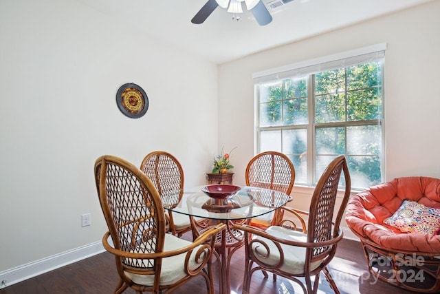 dining room with ceiling fan and dark hardwood / wood-style floors