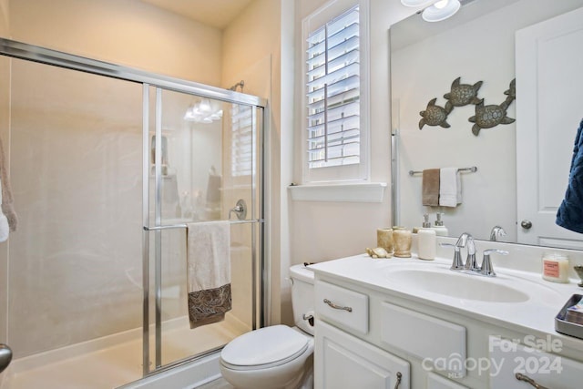 bathroom featuring walk in shower, vanity, and toilet