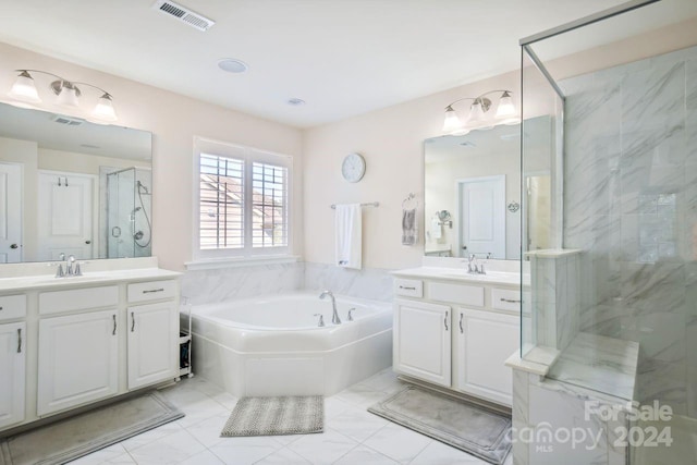 bathroom with vanity and independent shower and bath