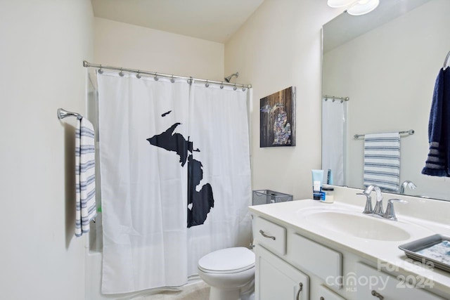 bathroom featuring a shower with curtain, vanity, and toilet