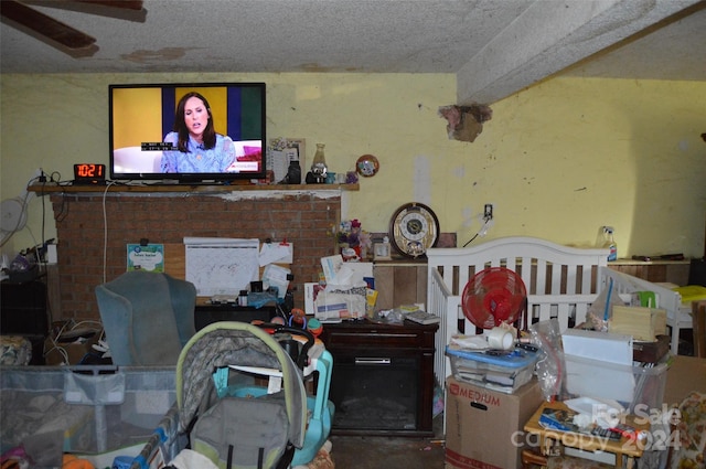 interior space with ceiling fan and a textured ceiling