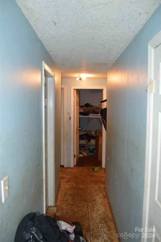 hallway featuring a textured ceiling