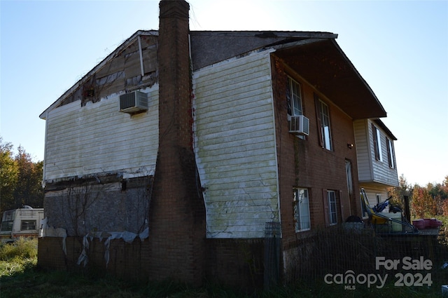 view of side of home featuring cooling unit