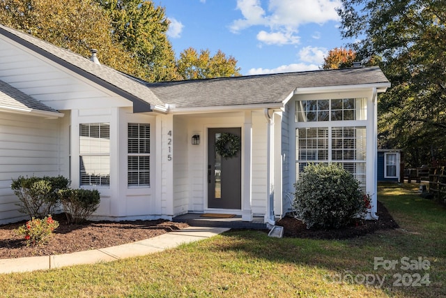 doorway to property featuring a yard