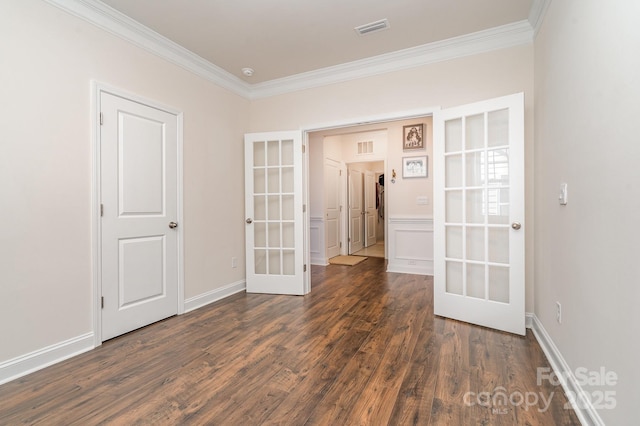 spare room with french doors, dark hardwood / wood-style flooring, and ornamental molding