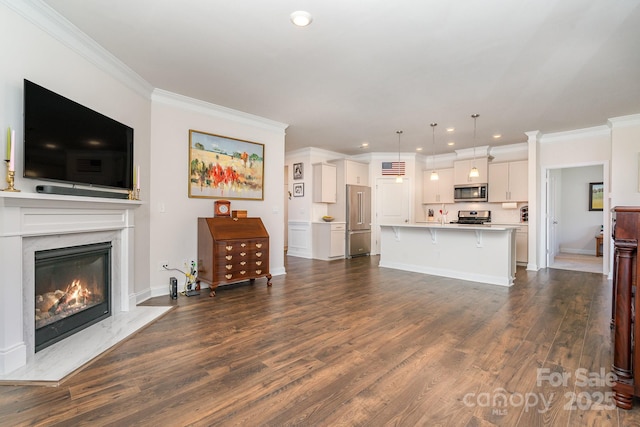 living room featuring dark hardwood / wood-style floors, a premium fireplace, and crown molding