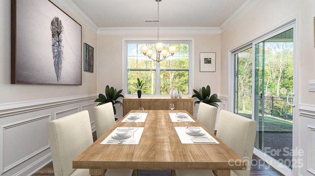 dining room with dark wood-type flooring, an inviting chandelier, a wealth of natural light, and crown molding