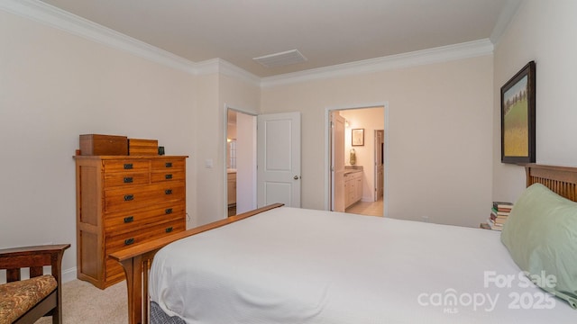 bedroom with ensuite bathroom, crown molding, and light carpet