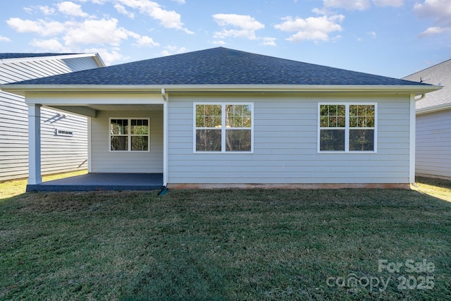 rear view of house featuring a lawn and a patio area