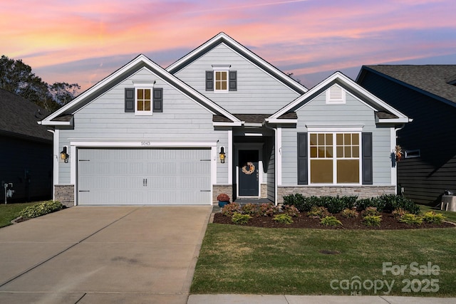 craftsman-style home featuring a yard and a garage