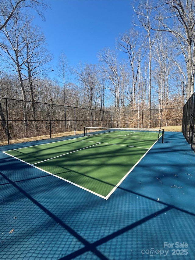 view of tennis court featuring fence