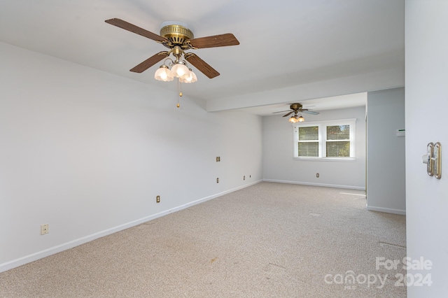 spare room with ceiling fan and light carpet