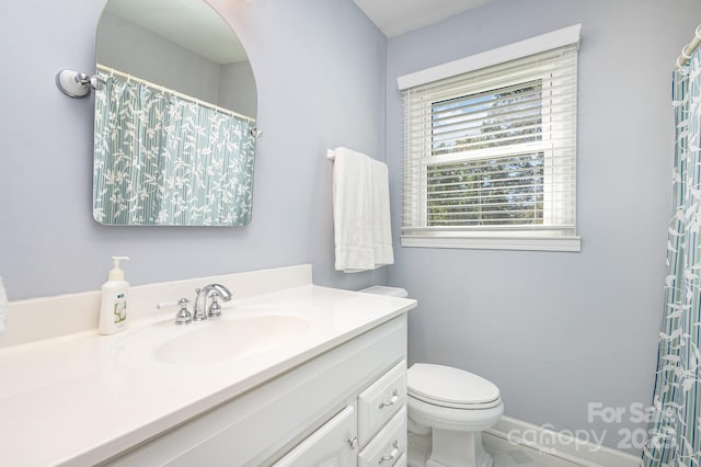 full bathroom with toilet, baseboards, and vanity