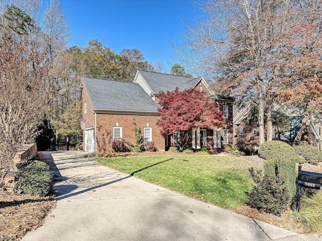 view of front of home with a garage and a front yard