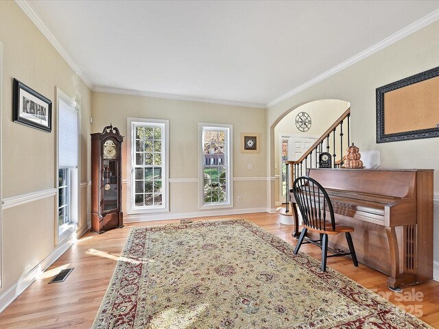 office space featuring ornamental molding and light hardwood / wood-style floors