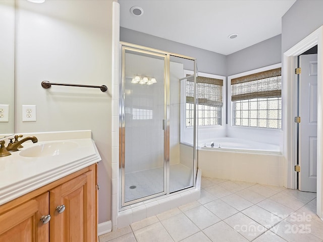 bathroom with vanity, tile patterned flooring, and plus walk in shower