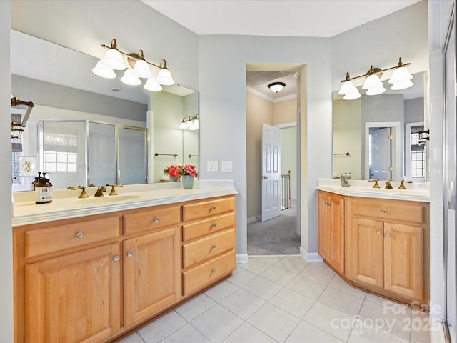 bathroom featuring ornamental molding, vanity, tile patterned flooring, and a shower with door