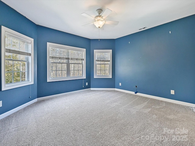 carpeted empty room featuring ceiling fan