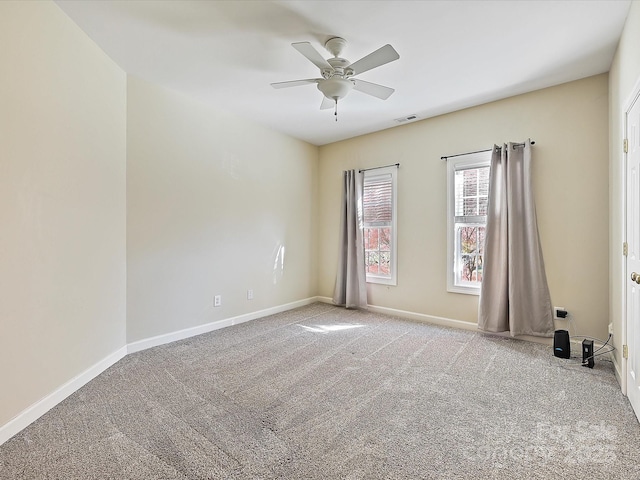 carpeted spare room with ceiling fan