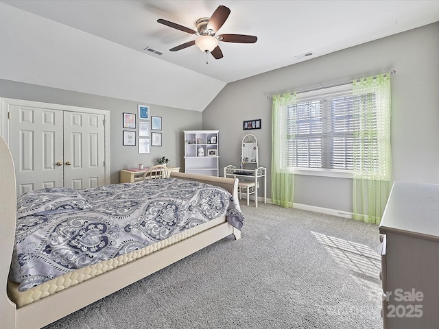 bedroom with vaulted ceiling, a closet, ceiling fan, and carpet