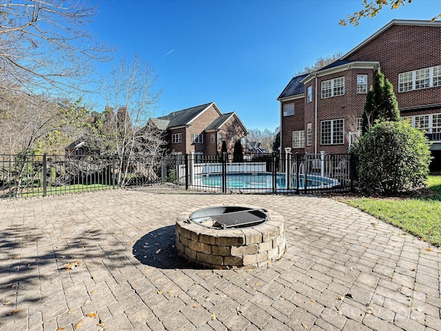 view of swimming pool featuring a patio area and a fire pit