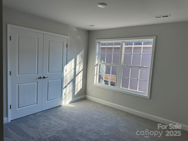 unfurnished bedroom featuring a closet and carpet