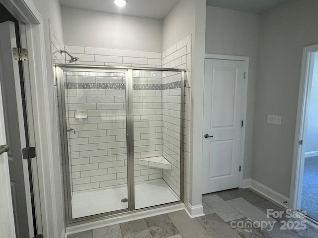 bathroom with a shower with door