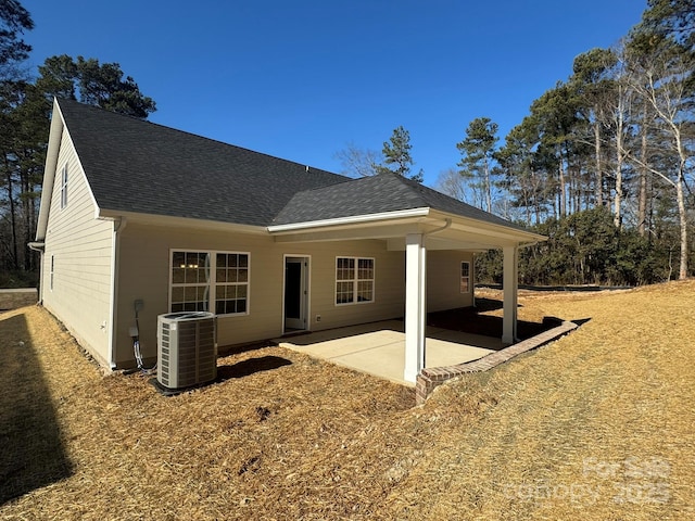 rear view of house with central AC and a patio