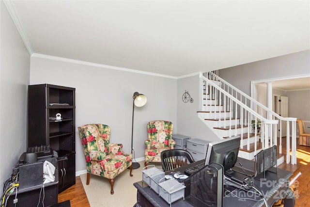 interior space with hardwood / wood-style flooring, crown molding, and decorative columns