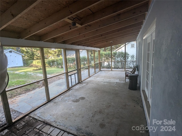 unfurnished sunroom with vaulted ceiling