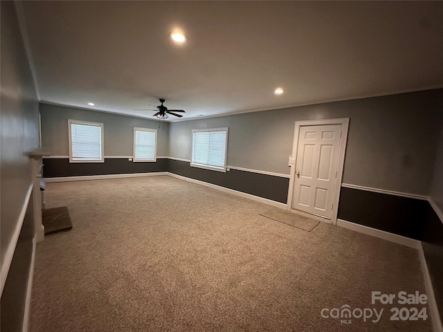 unfurnished room featuring ceiling fan and carpet floors