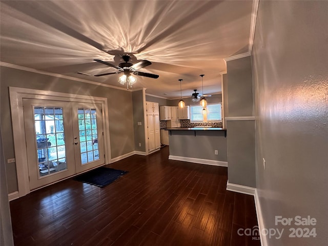 unfurnished living room with ornamental molding, ceiling fan, french doors, and dark hardwood / wood-style flooring